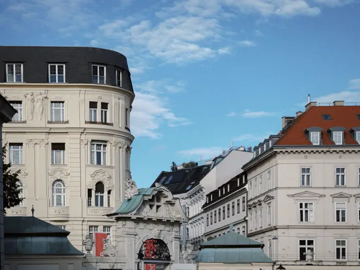 Ornate historic buildings in Vienna under a clear blue sky.